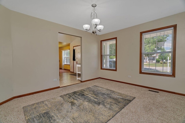 4218 Glenlo Dr, Plainfield, IL 60586 - carpeted empty room with healthy amount of natural light and a chandelier