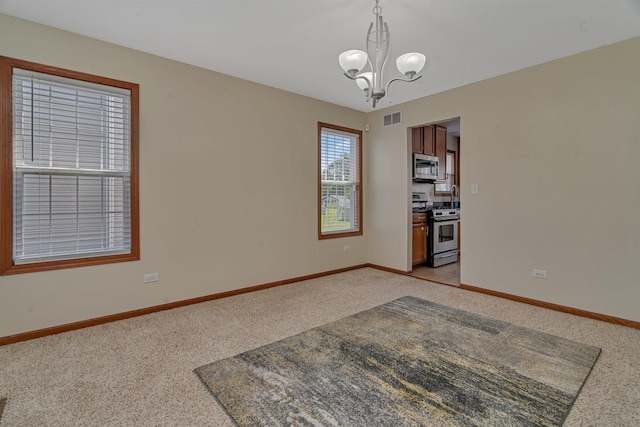 4218 Glenlo Dr, Plainfield, IL 60586 - empty room featuring light colored carpet and a chandelier