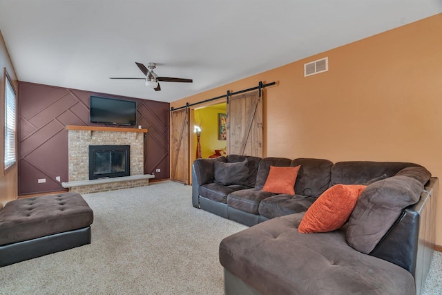 4218 Glenlo Dr, Plainfield, IL 60586 - carpeted living room featuring ceiling fan, a barn door, and a fireplace