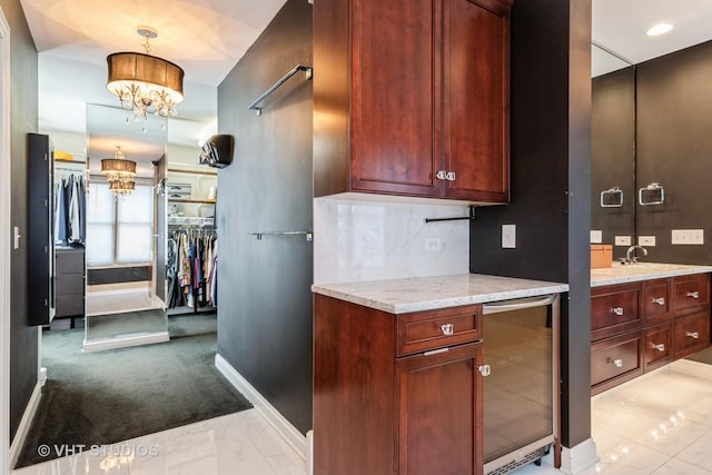 1867 Admiral Ct, Glenview, IL 60026 - kitchen with a chandelier, beverage cooler, light marble finish floors, light stone countertops, and light carpet