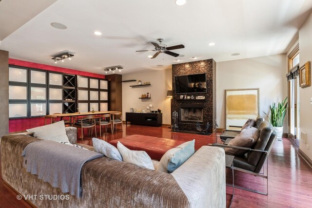 1867 Admiral Ct, Glenview, IL 60026 - living room with wood finished floors, a tiled fireplace, a ceiling fan, and recessed lighting
