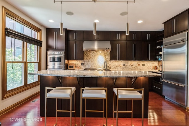 1867 Admiral Ct, Glenview, IL 60026 - kitchen featuring stainless steel appliances, under cabinet range hood, dark wood-style flooring, healthy amount of natural light, and recessed lighting