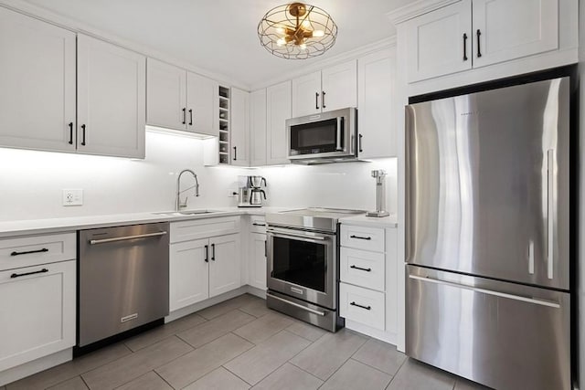 1450 N Astor St Unit 5C, Chicago, IL 60610 - kitchen with appliances with stainless steel finishes, light countertops, white cabinetry, and light tile patterned floors