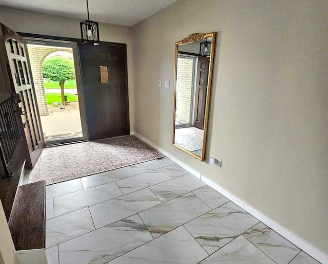 12416 W Prairie Dr, Homer Glen, IL 60491 - foyer featuring marble finish flooring and baseboards