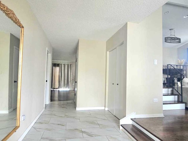 12416 W Prairie Dr, Homer Glen, IL 60491 - corridor with marble finish flooring, a textured ceiling, and stairs