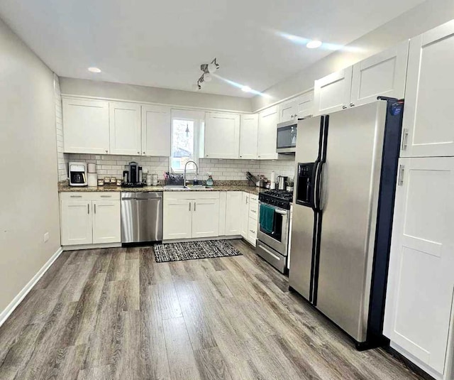 12416 W Prairie Dr, Homer Glen, IL 60491 - kitchen with appliances with stainless steel finishes, wood finished floors, white cabinets, decorative backsplash, and recessed lighting