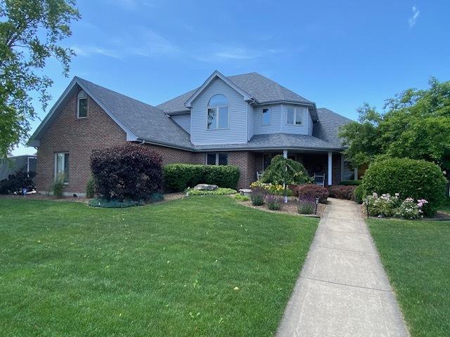 19338 Kickapoo Dr, Tinley Park, IL 60487 - traditional-style house with a front lawn and brick siding