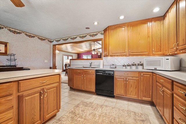 13079 N 1800 E Rd, Pontiac, IL 61764 - kitchen featuring dishwasher, white microwave, light countertops, ceiling fan, and tasteful backsplash