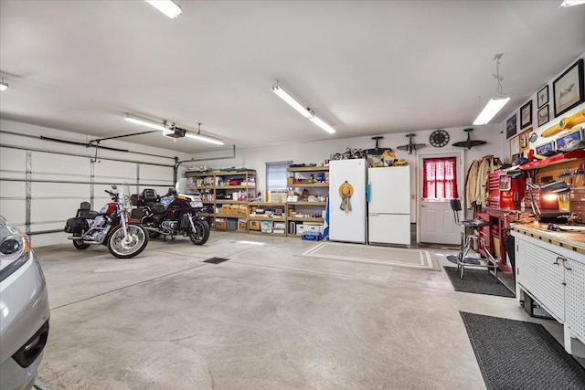 13079 N 1800 E Rd, Pontiac, IL 61764 - garage with freestanding refrigerator, a garage door opener, and a workshop area