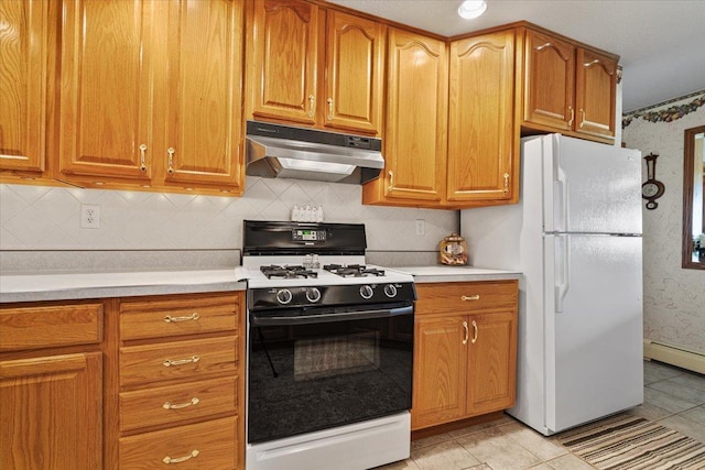 13079 N 1800 E Rd, Pontiac, IL 61764 - kitchen with gas range oven, under cabinet range hood, freestanding refrigerator, light countertops, and backsplash