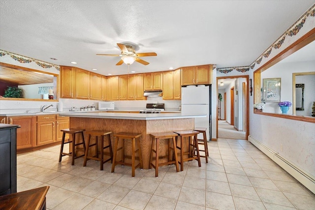 13079 N 1800 E Rd, Pontiac, IL 61764 - kitchen with white appliances, under cabinet range hood, a baseboard radiator, a ceiling fan, and light tile patterned floors