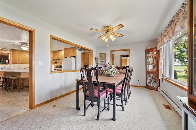 13079 N 1800 E Rd, Pontiac, IL 61764 - dining area with ceiling fan, a baseboard radiator, and light carpet
