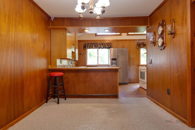 80 N Lake Ave, Third Lake, IL 60030 - kitchen featuring high end fridge, white gas stove, brown cabinets, a chandelier, and light colored carpet
