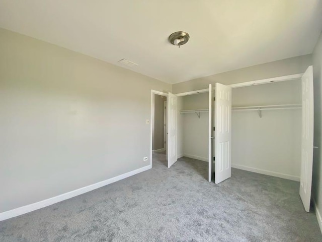 9159 S Dobson Ave, Chicago, IL 60619 - unfurnished bedroom featuring two closets and carpet flooring