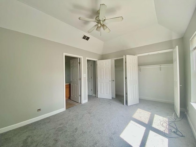 9159 S Dobson Ave, Chicago, IL 60619 - unfurnished bedroom featuring multiple closets, carpet flooring, vaulted ceiling, and a ceiling fan