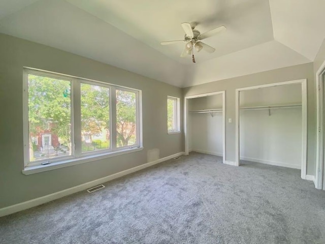 9159 S Dobson Ave, Chicago, IL 60619 - unfurnished bedroom featuring two closets, carpet floors, a ceiling fan, and a tray ceiling