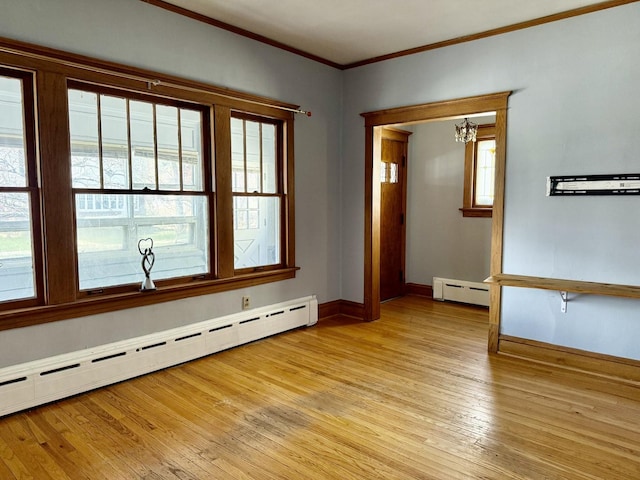 826 S E Ave, Oak Park, IL 60304 - empty room featuring a baseboard heating unit, baseboard heating, crown molding, light wood finished floors, and a chandelier
