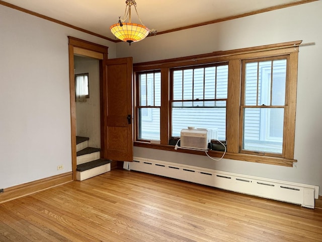 826 S E Ave, Oak Park, IL 60304 - spare room featuring baseboard heating, crown molding, light wood-style floors, stairway, and healthy amount of natural light