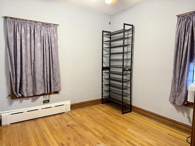 826 S E Ave, Oak Park, IL 60304 - unfurnished bedroom with a baseboard heating unit and wood finished floors