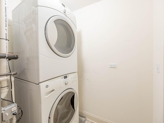 1670 Mill St Unit 208, Des Plaines, IL 60016 - laundry area with stacked washing machine and dryer and baseboards