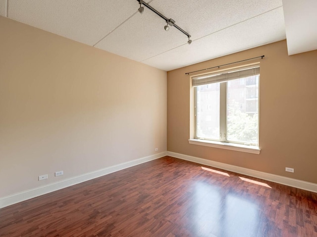 1670 Mill St Unit 208, Des Plaines, IL 60016 - empty room with dark wood-type flooring, track lighting, and a textured ceiling
