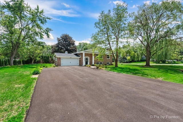 27W075 Fleming Dr, Winfield, IL 60190 - neoclassical / greek revival house featuring asphalt driveway, a garage, a front yard, brick siding, and view of wooded area