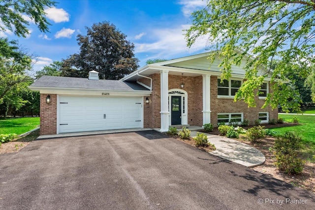 27W075 Fleming Dr, Winfield, IL 60190 - view of front of house with brick siding, driveway, and a garage