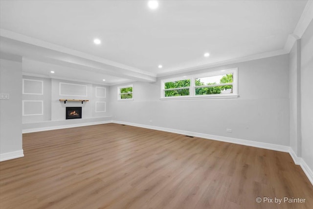 27W075 Fleming Dr, Winfield, IL 60190 - unfurnished living room featuring light wood-type flooring, ornamental molding, recessed lighting, and a lit fireplace