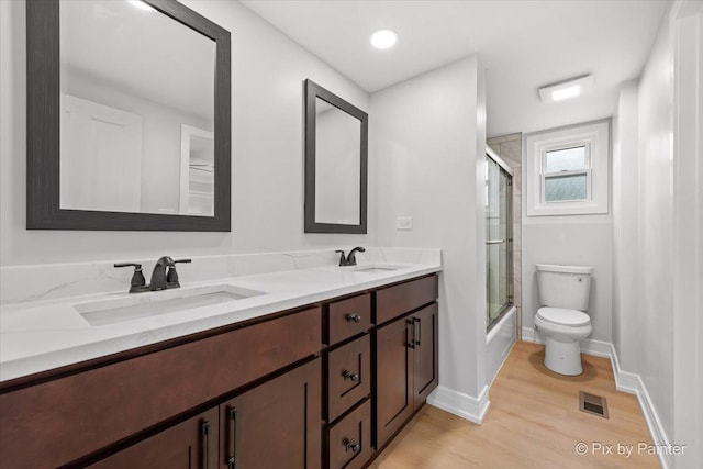 27W075 Fleming Dr, Winfield, IL 60190 - full bath with double vanity, wood finished floors, and shower / bath combination with glass door