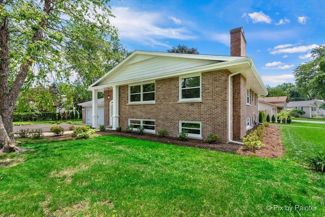 27W075 Fleming Dr, Winfield, IL 60190 - view of front of property with a chimney, a front yard, brick siding, an attached garage, and driveway