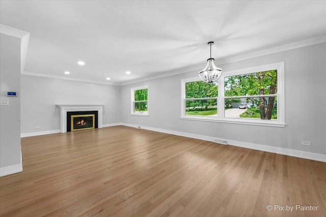 27W075 Fleming Dr, Winfield, IL 60190 - unfurnished living room with wood finished floors, a chandelier, crown molding, a warm lit fireplace, and recessed lighting