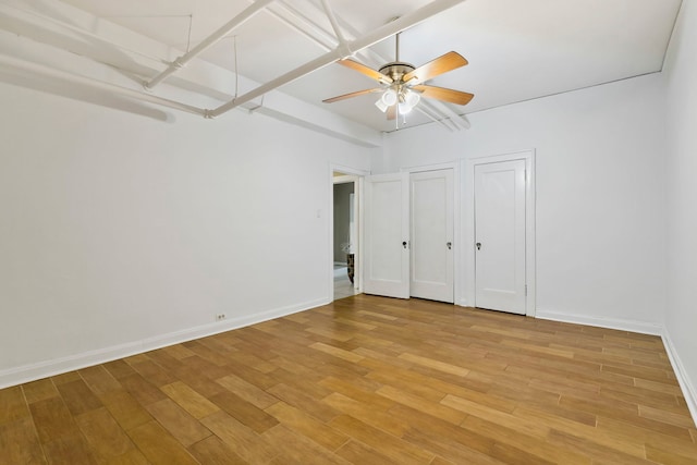 1360 E Madison Park Unit B, Chicago, IL 60615 - unfurnished bedroom with light wood-style floors, two closets, and a ceiling fan