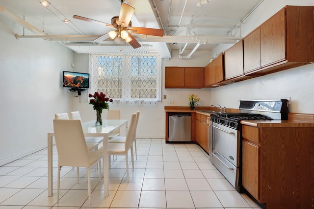 1360 E Madison Park Unit B, Chicago, IL 60615 - kitchen featuring appliances with stainless steel finishes, ceiling fan, brown cabinetry, beamed ceiling, and light tile patterned floors