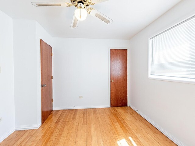 14732 Dorchester Ave, Dolton, IL 60419 - spare room featuring light wood finished floors and a ceiling fan