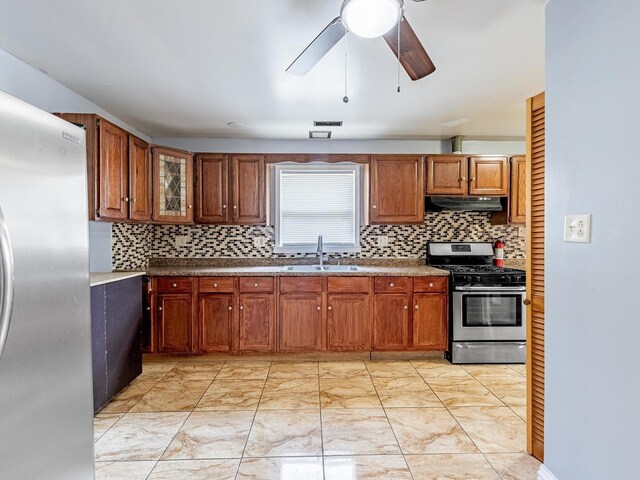 14732 Dorchester Ave, Dolton, IL 60419 - kitchen with appliances with stainless steel finishes, under cabinet range hood, light marble finish floors, and backsplash