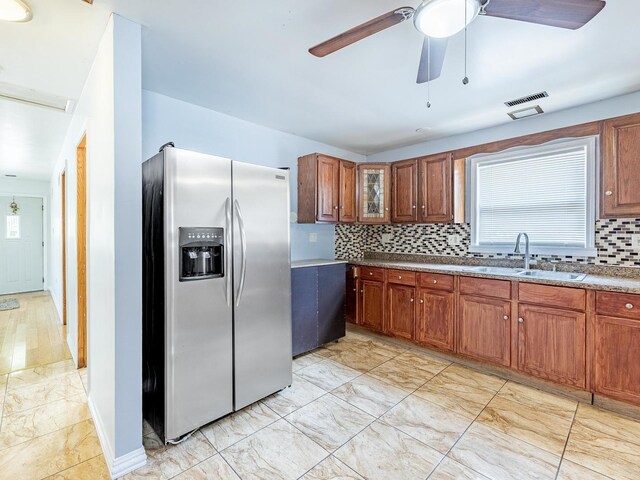 14732 Dorchester Ave, Dolton, IL 60419 - kitchen with stainless steel refrigerator with ice dispenser, light marble finish flooring, backsplash, a ceiling fan, and brown cabinets