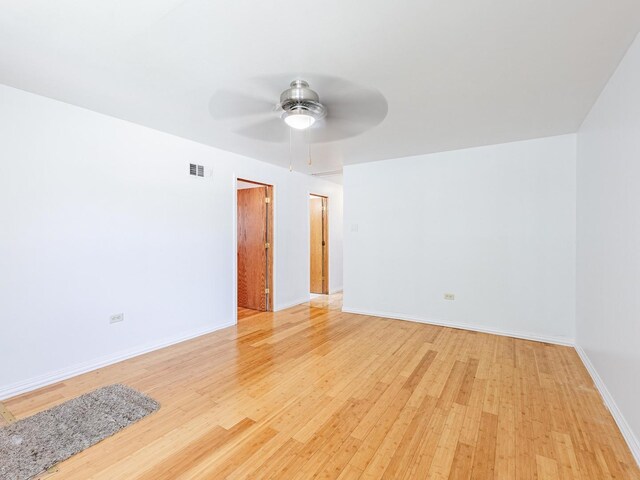 14732 Dorchester Ave, Dolton, IL 60419 - empty room featuring light wood-style flooring and a ceiling fan