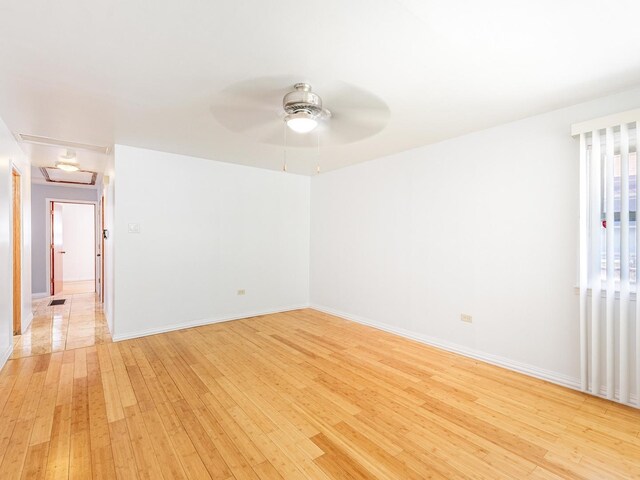 14732 Dorchester Ave, Dolton, IL 60419 - unfurnished room featuring light wood-style floors and ceiling fan