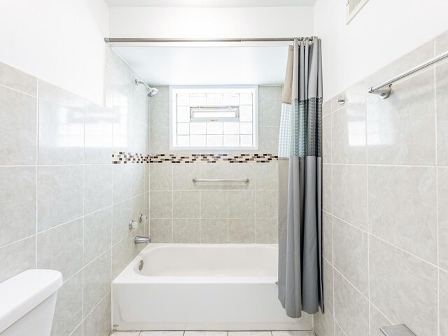 14732 Dorchester Ave, Dolton, IL 60419 - full bathroom with tile walls and shower / bath combination with curtain