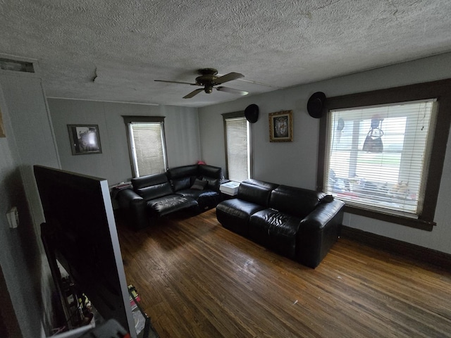 544 Charles St, Aurora, IL 60506 - living area featuring wood finished floors, a textured ceiling, a ceiling fan, and plenty of natural light