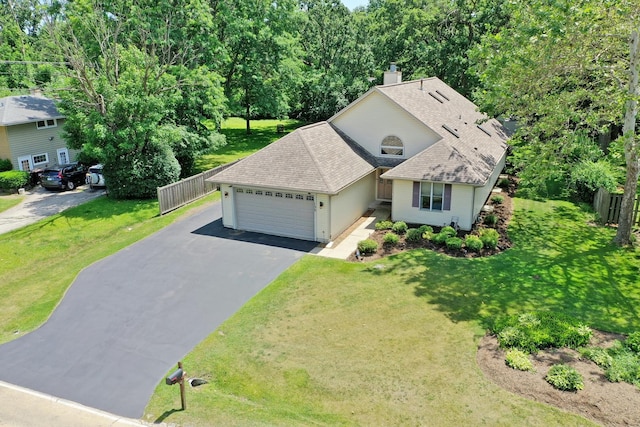 135 Miller Rd, Lake Zurich, IL 60047 - view of front of property featuring an attached garage, roof with shingles, a chimney, and driveway