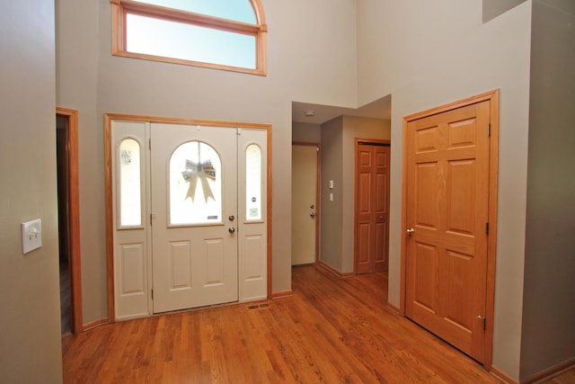 135 Miller Rd, Lake Zurich, IL 60047 - entrance foyer with a high ceiling and light wood-style flooring
