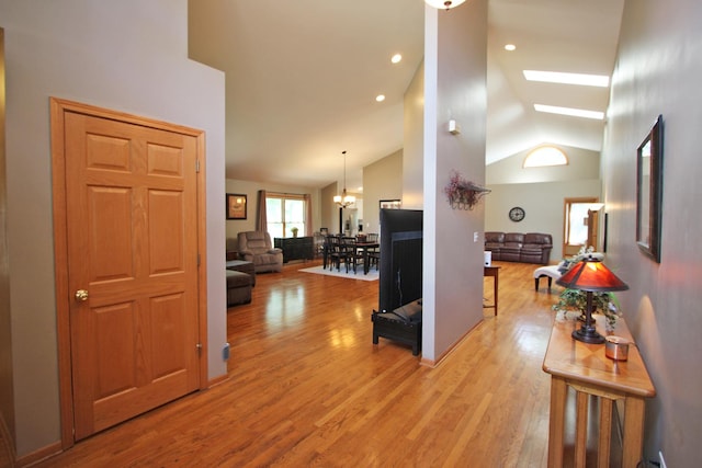 135 Miller Rd, Lake Zurich, IL 60047 - hall with light wood-type flooring, vaulted ceiling, a chandelier, and a skylight