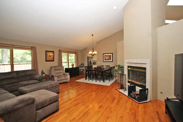 135 Miller Rd, Lake Zurich, IL 60047 - living room with a chandelier, light wood-style floors, a fireplace with flush hearth, high vaulted ceiling, and recessed lighting