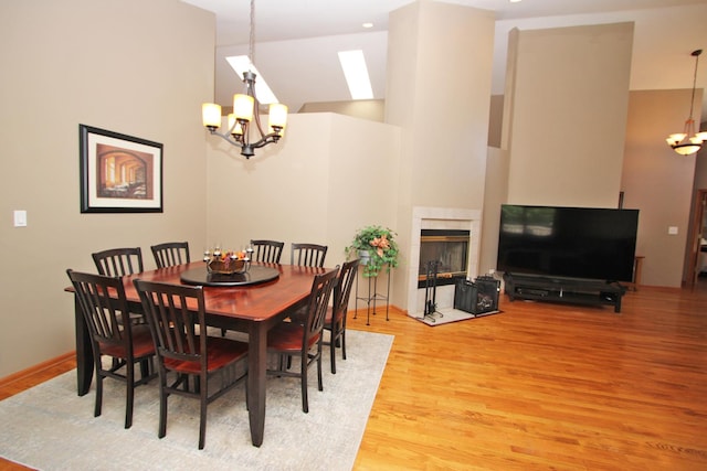 135 Miller Rd, Lake Zurich, IL 60047 - dining area with a chandelier, light wood finished floors, and a tiled fireplace