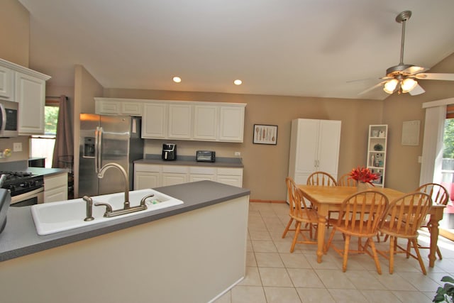 135 Miller Rd, Lake Zurich, IL 60047 - kitchen with stainless steel appliances, dark countertops, white cabinets, recessed lighting, and ceiling fan