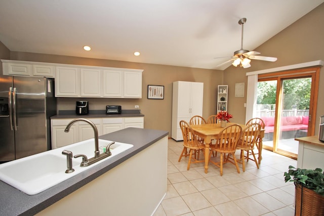 135 Miller Rd, Lake Zurich, IL 60047 - kitchen featuring stainless steel fridge with ice dispenser, dark countertops, ceiling fan, vaulted ceiling, and white cabinets