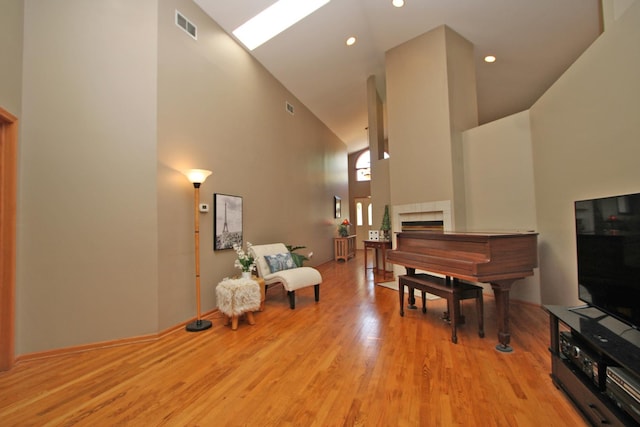 135 Miller Rd, Lake Zurich, IL 60047 - sitting room with high vaulted ceiling, wood finished floors, a tile fireplace, and recessed lighting