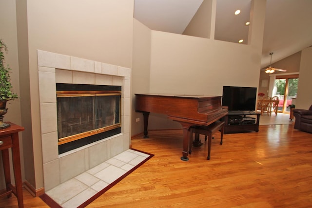135 Miller Rd, Lake Zurich, IL 60047 - living room featuring a tile fireplace, high vaulted ceiling, wood finished floors, and a ceiling fan