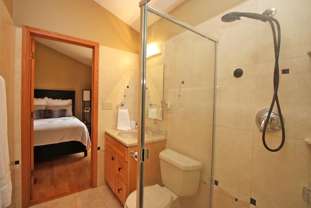 135 Miller Rd, Lake Zurich, IL 60047 - full bath with vaulted ceiling, vanity, connected bathroom, a shower stall, and tile patterned flooring